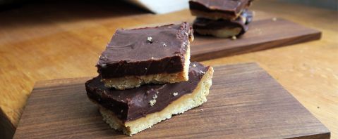 morceaux carrés de tarte au beurre de cacahuètes et ganache au chocolat